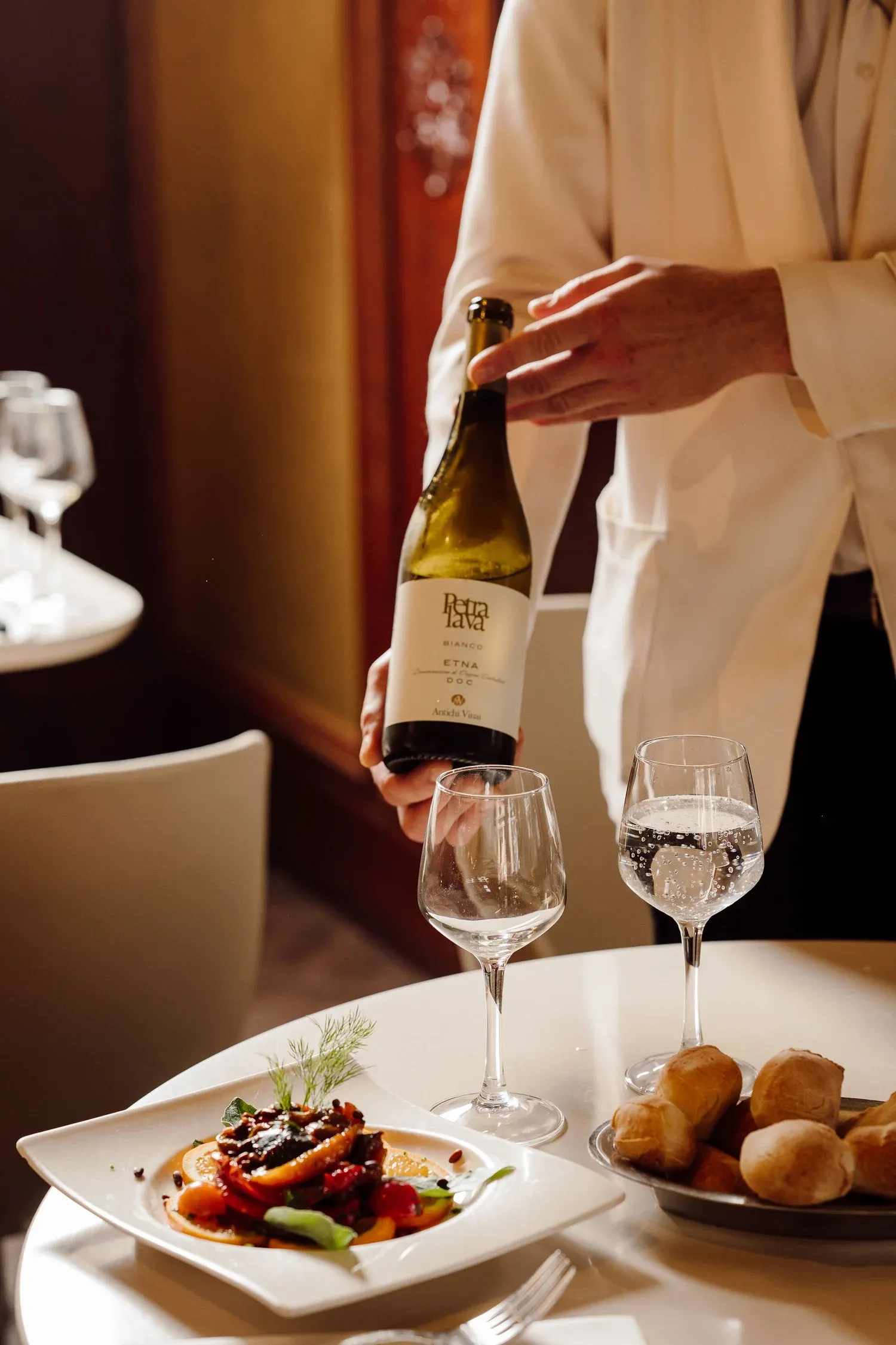 White wine poured tableside at Gran Caffè Convivium.