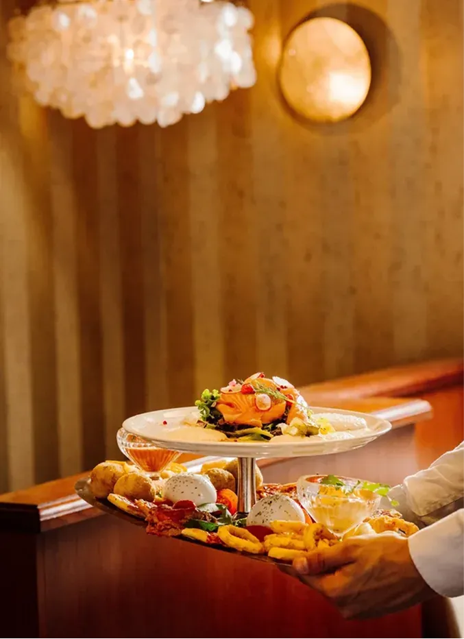A tiered platter of smoked salmon and antipasti carried through the dining room